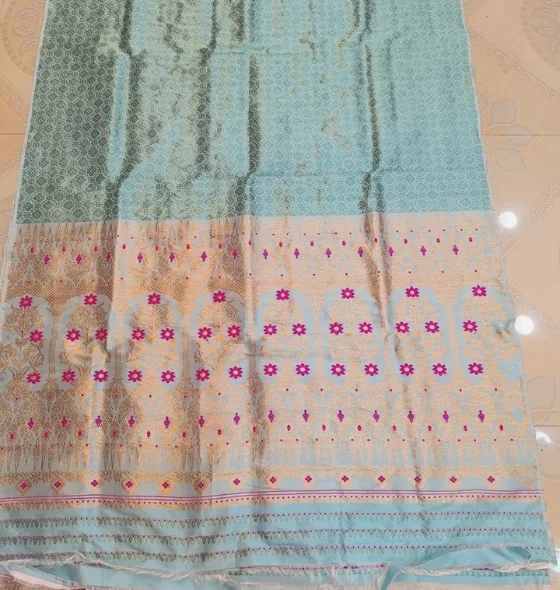 Pure Paat Sador mekhela in light blue color in Heavy guna work.